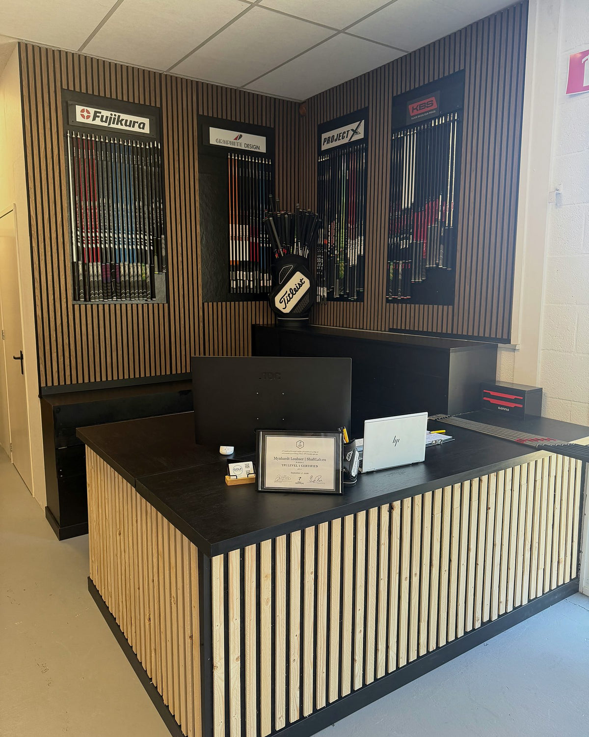 Workshop reception desk with the shaft walls behind it